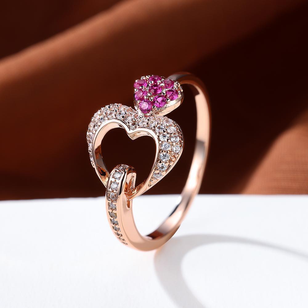 Double Heart Shaped Ring features an Inlaid Pink Zircon and is plated with 18K Gold