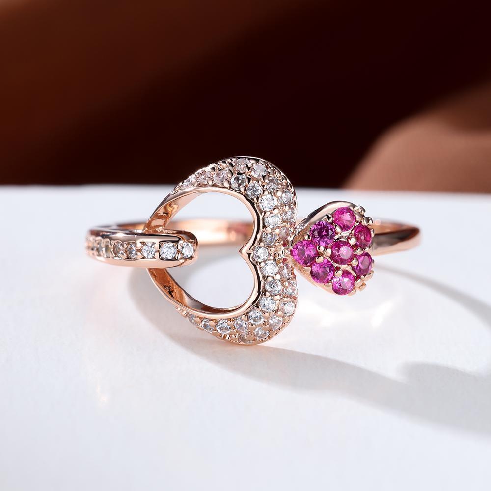 Double Heart Shaped Ring features an Inlaid Pink Zircon and is plated with 18K Gold