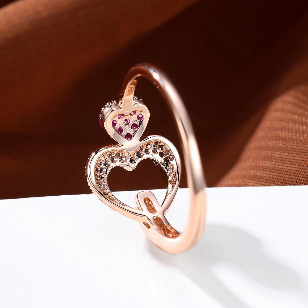 Double Heart Shaped Ring features an Inlaid Pink Zircon and is plated with 18K Gold